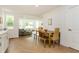 Bright dining area featuring wood table and bench seating in an open concept floor plan with hardwood floors at 1026 Jefferson Ave, Indianapolis, IN 46201