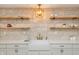 Close-up of a modern kitchen featuring a farmhouse sink and stone backsplash at 1026 Jefferson Ave, Indianapolis, IN 46201