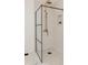 Modern shower with black trim glass and bronze shower head with white tiled walls at 1026 Jefferson Ave, Indianapolis, IN 46201