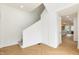 Bright stairway with herringbone flooring and view of the kitchen at 1026 Jefferson Ave, Indianapolis, IN 46201