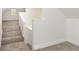 Carpeted staircase with a white wall leading to the upper level of the house at 1026 Jefferson Ave, Indianapolis, IN 46201