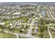 Panoramic aerial view of a neighborhood featuring houses, green spaces, and serene ponds at 10451 Meadow Lake Dr, Fishers, IN 46038