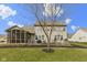 Spacious backyard showcasing a cozy screened-in porch, open patio, and lush green lawn at 10451 Meadow Lake Dr, Fishers, IN 46038