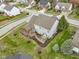 Aerial view of a home's backyard with a deck, patio, lush lawn, and tasteful landscaping at 10451 Meadow Lake Dr, Fishers, IN 46038
