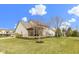 Well-maintained backyard featuring a screened-in porch and a spacious lawn perfect for outdoor activities at 10451 Meadow Lake Dr, Fishers, IN 46038