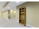 Finished basement hallway featuring neutral carpet and a wooden bookshelf, providing ample storage at 10451 Meadow Lake Dr, Fishers, IN 46038