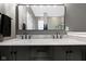 This bathroom includes a double vanity with stone countertops and modern fixtures at 10451 Meadow Lake Dr, Fishers, IN 46038