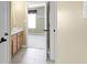 Bathroom entrance adjacent to a bedroom, featuring a vanity with light wood cabinets at 10451 Meadow Lake Dr, Fishers, IN 46038