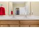 Bathroom with a double vanity and a large mirror, reflecting an adjacent room at 10451 Meadow Lake Dr, Fishers, IN 46038