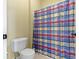 Bathroom with a white toilet and a colorful plaid shower curtain at 10451 Meadow Lake Dr, Fishers, IN 46038
