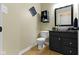 Chic bathroom with a vessel sink, black vanity, decorative wall art, and wood-look flooring at 10451 Meadow Lake Dr, Fishers, IN 46038