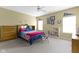 Bedroom featuring sports memorabilia, neutral carpet, ceiling fan, and natural light at 10451 Meadow Lake Dr, Fishers, IN 46038