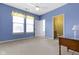 Bright bedroom featuring blue walls, ample natural light, and neutral carpeting, creating a serene atmosphere at 10451 Meadow Lake Dr, Fishers, IN 46038