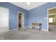 Spacious bedroom with blue walls, neutral carpet, and a ceiling fan at 10451 Meadow Lake Dr, Fishers, IN 46038