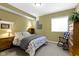 Charming bedroom featuring neutral colors, a side table, and a comfortable bed at 10451 Meadow Lake Dr, Fishers, IN 46038