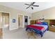 Bedroom featuring sports memorabilia, neutral carpet, ceiling fan, and natural light at 10451 Meadow Lake Dr, Fishers, IN 46038