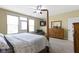 This bedroom features a four-poster bed, dresser, and sitting area with backyard access at 10451 Meadow Lake Dr, Fishers, IN 46038