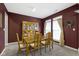 Formal dining room with large windows and a wooden table with seating for six at 10451 Meadow Lake Dr, Fishers, IN 46038