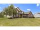 Attractive two-story brick home featuring mature trees and a well-maintained front lawn, ideal for Gathering living at 10451 Meadow Lake Dr, Fishers, IN 46038