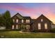Charming two-story brick home with a manicured lawn and inviting front porch, perfect for suburban living at 10451 Meadow Lake Dr, Fishers, IN 46038
