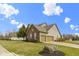 Residential home showing a three-car garage, manicured lawn and landscaping at 10451 Meadow Lake Dr, Fishers, IN 46038