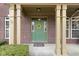 Close-up of the home's entrance featuring a green front door with yellow wreath, and well-maintained brick facade at 10451 Meadow Lake Dr, Fishers, IN 46038