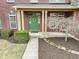 Charming front porch features a green door, welcoming wreath, and manicured landscaping, enhancing curb appeal at 10451 Meadow Lake Dr, Fishers, IN 46038