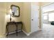 Inviting hallway featuring neutral decor, a decorative mirror, and a glimpse into another room at 10451 Meadow Lake Dr, Fishers, IN 46038