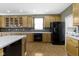 Well-lit kitchen featuring oak cabinets, black appliances, light countertops and a tiled backsplash at 10451 Meadow Lake Dr, Fishers, IN 46038