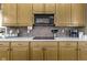 Modern kitchen with lots of wooden cabinets, stainless steel microwave, and colorful backsplash at 10451 Meadow Lake Dr, Fishers, IN 46038
