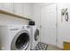 Convenient laundry room with a modern washer and dryer set, overhead cabinets, and a practical layout at 10451 Meadow Lake Dr, Fishers, IN 46038