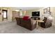 Comfortable living room featuring carpet, fireplace, a large-screen TV, and cozy furniture at 10451 Meadow Lake Dr, Fishers, IN 46038