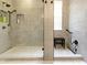This walk-in shower offers a modern design with bench, rainfall shower head, and storage niches at 10451 Meadow Lake Dr, Fishers, IN 46038