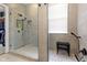 This walk-in shower offers a modern design with bench, rainfall shower head, and storage niches at 10451 Meadow Lake Dr, Fishers, IN 46038
