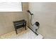 Modern shower with tile surround, rainfall shower head, handheld sprayer, and a small bench at 10451 Meadow Lake Dr, Fishers, IN 46038
