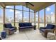 Inviting sunroom with comfortable wicker furniture and scenic neighborhood views at 10451 Meadow Lake Dr, Fishers, IN 46038