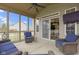 Enclosed porch with cozy seating and a sliding door entrance to the dining area, offering relaxing views at 10451 Meadow Lake Dr, Fishers, IN 46038