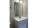 Bathroom with white vanity, large mirror, and modern lighting at 10622 Howe Rd, Fishers, IN 46038