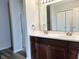 Bathroom vanity featuring double sinks, elegant mirrors, and a nearby shower stall at 10622 Howe Rd, Fishers, IN 46038
