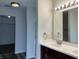 Bathroom vanity with double sinks, granite counters, and modern lighting at 10622 Howe Rd, Fishers, IN 46038