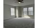 Spacious bedroom featuring neutral carpet, a ceiling fan, and bright natural light at 10622 Howe Rd, Fishers, IN 46038