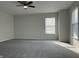 Bright bedroom featuring a ceiling fan and lots of natural light from a large window at 10622 Howe Rd, Fishers, IN 46038