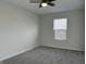 Bright bedroom features a ceiling fan and a large window at 10622 Howe Rd, Fishers, IN 46038