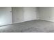 Neutral bedroom featuring gray carpet, white walls, and closet space at 10622 Howe Rd, Fishers, IN 46038