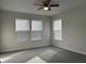 This bright bedroom features a ceiling fan and two large windows at 10622 Howe Rd, Fishers, IN 46038