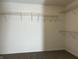 Walk-in closet with carpet and metal shelving ready to organize all your outfits and accessories at 10622 Howe Rd, Fishers, IN 46038