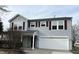 Two-story home featuring light-gray siding, bright white trim, and a white two-car garage at 10622 Howe Rd, Fishers, IN 46038