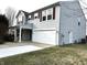 This lovely home boasts light gray vinyl siding and a spacious two-car garage at 10622 Howe Rd, Fishers, IN 46038