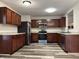 Kitchen featuring stainless steel appliances, wood cabinets, and stylish floors at 10622 Howe Rd, Fishers, IN 46038