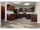 Kitchen featuring stainless steel appliances, wood cabinets, and stylish floors at 10622 Howe Rd, Fishers, IN 46038